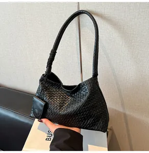 Detailed macro view of black woven Hobo shoulder bag with detachable mini pouch