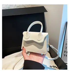 Detail of white lychee texture PU leather mini bag with flap and detachable strap