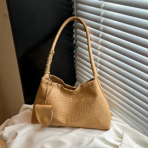 Khaki woven crescent hobo bag with twisted shoulder strap detail and mini pouch accessory