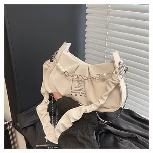 Detail of off-white ruched bag with pearl flower chain and stylish shoulder straps