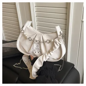 Detail of off-white baguette bag with pleated PU leather and pearl flower chain