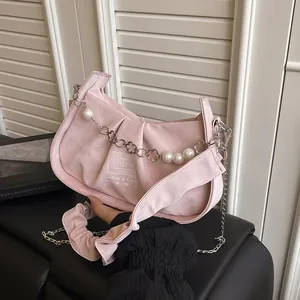 Pink suede baguette bag with pearl chain and floral metal buckle for women