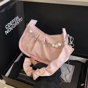 Chic pink pleated baguette shoulder bag with pearl flower chain and wide strap