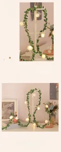 Detail of LED eucalyptus vine lights with white roses for warm room ambiance