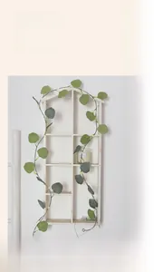 Detail of warm LED lights intertwined with artificial eucalyptus leaves and wire