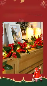 Close-up of festive LED string lights with artificial red berries and green leaves