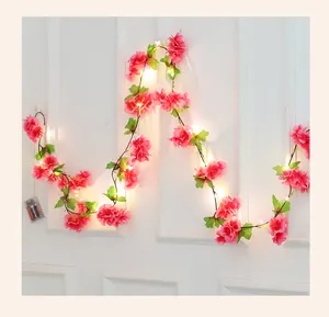 Detail of cherry blossom LED string light with battery box and warm yellow glow
