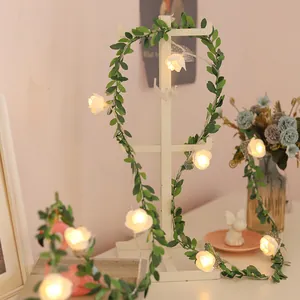 Artificial eucalyptus vine LED light string with white roses and warm yellow lighting