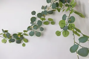 Détail de guirlande d'eucalyptus avec perles LED blanc chaud et feuilles vertes réalistes