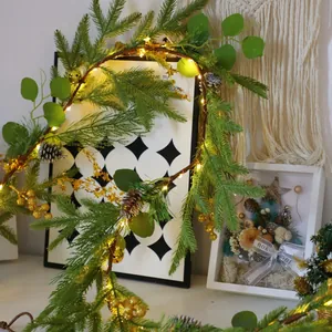 Christmas wreath with LED lights, pine needles, cones and golden star decorations