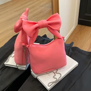 Chic pink bow-knot handbag with metal chain strap and soft leather finish for women
