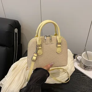 Fashionable straw shell handbag in beige and yellow leather with dual zip design