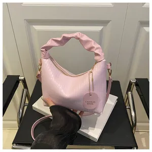 Detailed view of the light pink pleated texture fabric and stylish gathered top handle