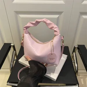 Pink pleated handbag with textured patterns and adjustable strap for women fashion
