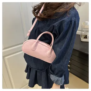 Detailansicht der rosa Baguette-Tasche aus PU-Leder mit silbernen Details am Denim
