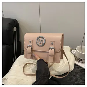 Stylish pink Cambridge satchel bag for women with metal M logo and chic double buckle front design.