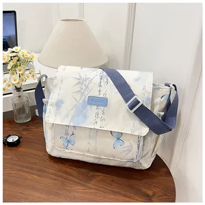 Detail of crossbody messenger bag featuring Chinese bamboo leaves and butterfly prints