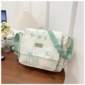 Detail of crossbody bag with butterfly print and mint green strap for daily use