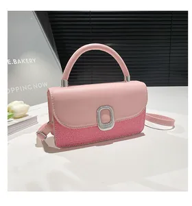 Close-up of pink crossbody bag with mixed textures, silver buckle, and adjustable strap