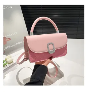 Close-up of pink crossbody bag featuring textured woven fabric and silver metal buckle