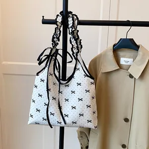 Sweet polka dot canvas tote with black bow prints and ruffled handles for women