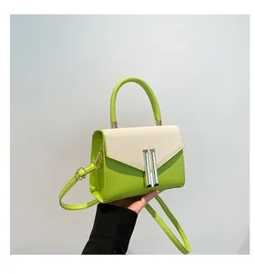 Detail showing contrast green leather and woven texture with a gold metal lock