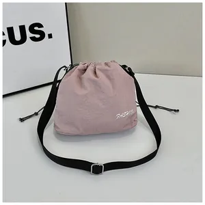 Detailed macro view of the dusty pink nylon bucket bag with fashion print and drawstring