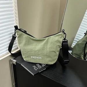 Light green nylon dumpling bag with adjustable strap and fashion lettering for women