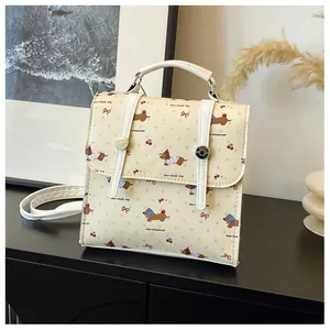 Detail of dachshund cartoon print and double buckle design on a mini PU backpack