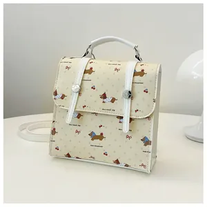 Detail of beige leather mini backpack with dachshund and cherry prints for women