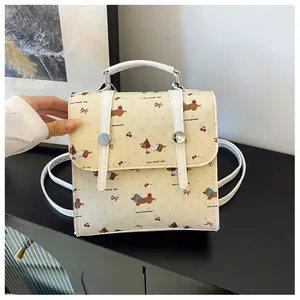 Detail of cream mini backpack with cartoon dachshund print and silver metal buckles