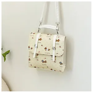 Detail of dachshund and cherry print on a minimalist cream white faux leather backpack