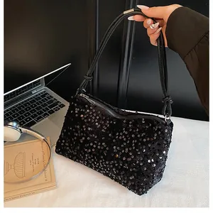 Detailed view of shimmering black sequins on the shoulder bag with leather knotted handle