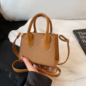 Caramel brown mini crossbody bag with woven texture and top handles for women