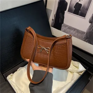 Chic brown crocodile embossed shoulder bag with gold bow clasp in a premium gift box