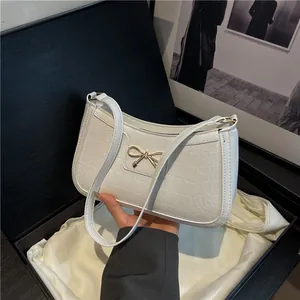 Chic white croc-embossed shoulder bag with elegant golden bow metal buckle detail