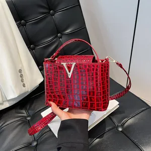 Chic red crocodile pattern handbag with silver V-clasp and adjustable shoulder strap
