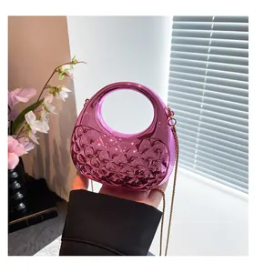 Close-up of metallic purple quilted acrylic crossbody bag with a golden chain strap