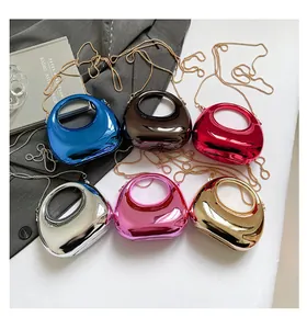 Detailed view of candy-colored acrylic evening bags with metallic finishes and chain straps