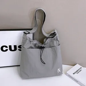 Light gray casual nylon crossbody bag with drawstring closure and white letter N embroidery