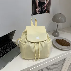 Fashionable pale yellow drawstring backpack with flap closure for a minimalist daily look