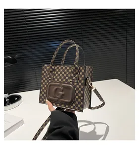 Detail of printed monogram crossbody bag with leather G logo and golden hardware
