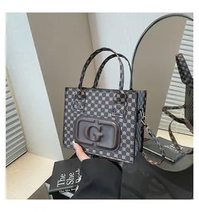 Close-up of vintage monogram crossbody bag with leather G emblem and twin handles