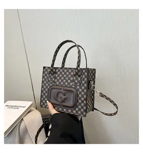 Detailed macro view of the vintage monogram pattern and embossed G logo on the square bag