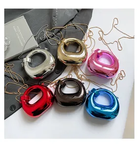 Detail of mini metallic hand bags in six vibrant candy colors with sleek chain straps