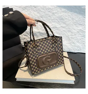 Macro detail of monogram square handbag with embossed G logo and fine leather strap
