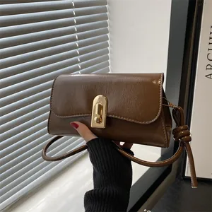 Retro brown faux leather baguette bag with gold clasp and adjustable knot strap