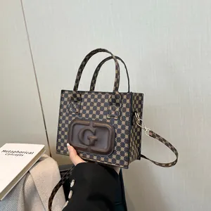 Retro monogram mini tote bag with embossed G logo and adjustable shoulder strap