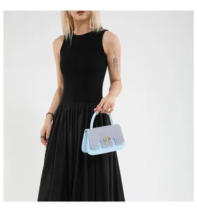 Dettaglio mini borsa azzurra glitterata con logo M dorato e manico superiore elegante