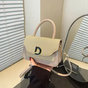 Chic beige crossbody bag with woven leather texture and elegant gold D-shaped buckle
